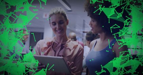 Businesswomen Collaborate Utilizing Digital Technology with Abstract Overlay