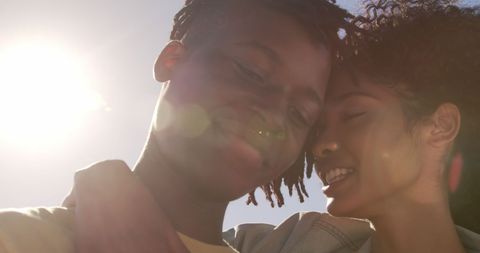 Happy Couple Embracing Under Sunny Beach Sky