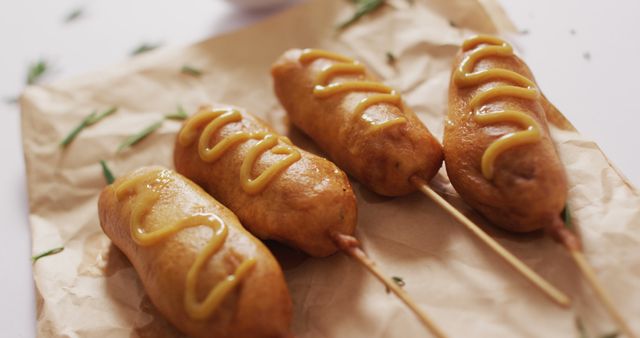 Image of corn dogs with dip on a white surface. food, cuisine and catering ingredients.