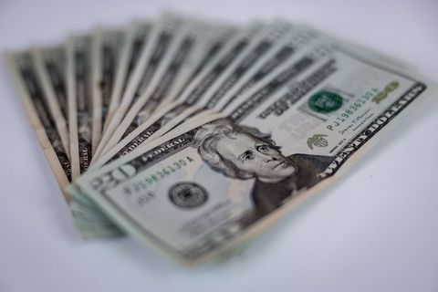 Row of Twenty Dollar Bills on White Surface