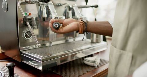 Barista Operating Professional Espresso Machine with Precision, Focus on Coffee Crafting
