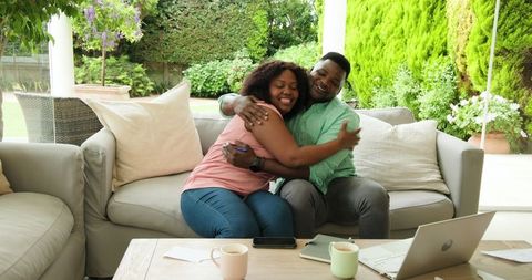Happy Couple Sharing Coffee and Embrace on Serene Patio