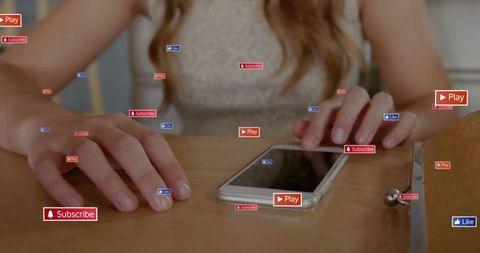 Woman touching smartphone on wooden table with floating social icons beside clutch purse