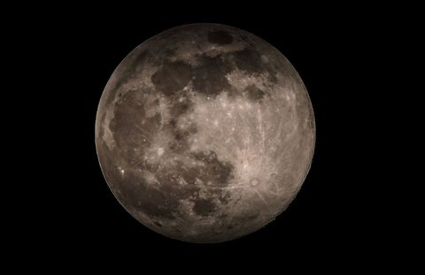 Full Moon with Detailed Surface and Shadows in Clear Night Sky