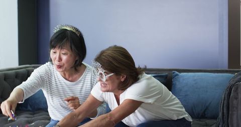 Joyful Senior Women Celebrating Birthday With Confetti