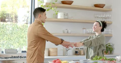 Couple Connecting Across Kitchen Island in Warm Modern Space