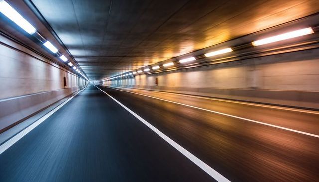 Underground tunnel converging to vanishing point with motion blur and warm lights