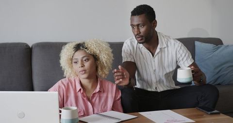 Friends in home office discussing creative project