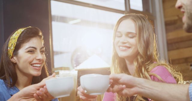 Friends Toasting With Coffee Cups In Cheerful Cafe Ambience - Download Free Stock Images Pikwizard.com