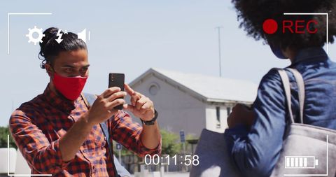 Diverse Friends Capturing a Moment with Masks and Mobile