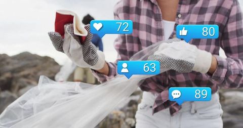 Volunteer collecting litter on beach with social media notifications
