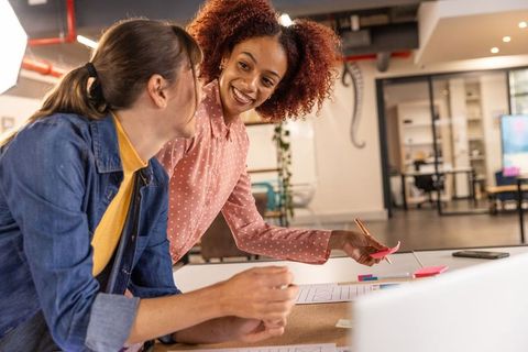 Diverse female colleagues collaborating on creative project