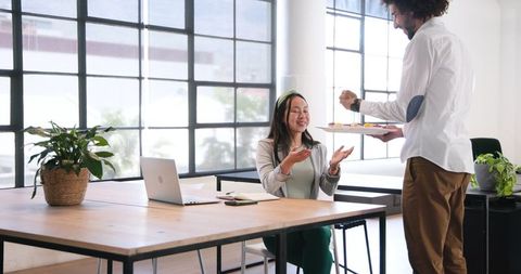 Colleagues Sharing Cake in Festive Office Celebration