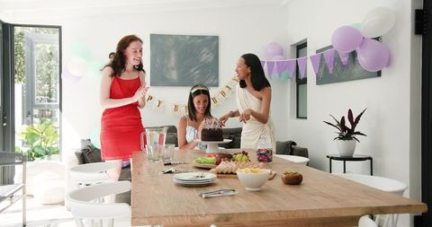 Diverse Women Enjoying Birthday Celebration at Sunny Home