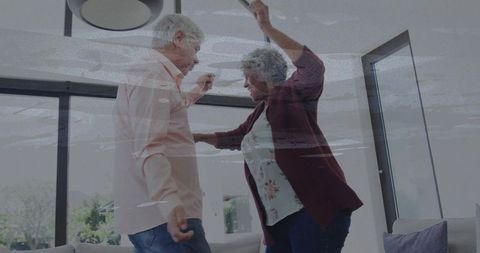 Joyful Senior Couple Dancing in Modern Living Room