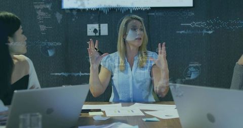 Business Professionals Engaging in Strategic Meeting with Technology Focus