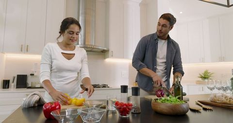Couple Cooking Fresh Salad in Modern Kitchen