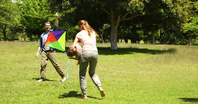 Family Enjoying Sunny Day Flying Colorful Kite in Park - Download Free Stock Images Pikwizard.com