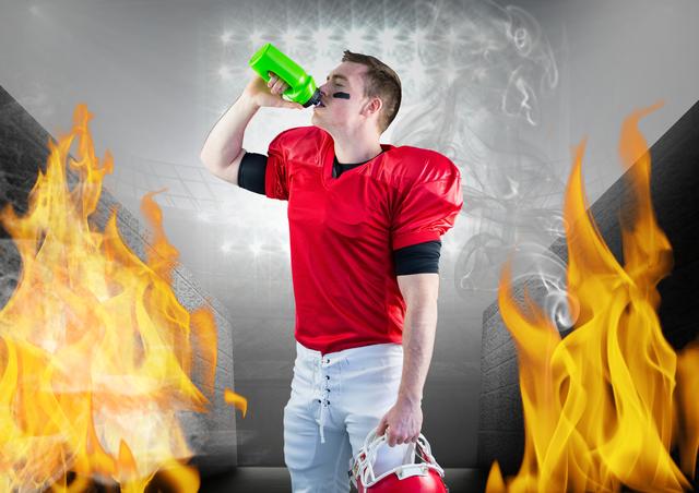 Digital composition of player drinking energy drink in stadium against fire in background