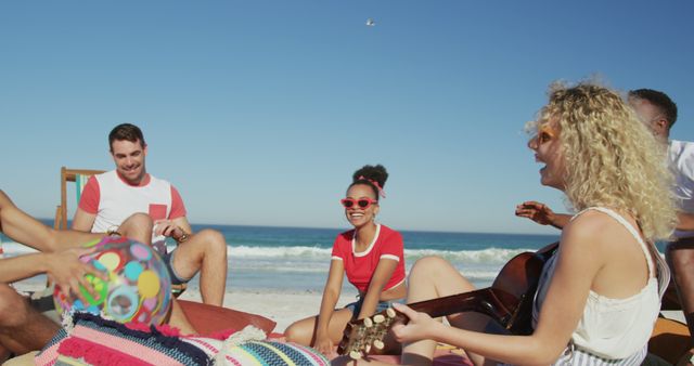 Young Friends Enjoying Beach Day with Guitar and Colorful Ball - Download Free Stock Images Pikwizard.com