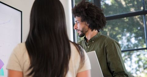 Colleagues Collaborating in Office Meeting on Digital Presentation