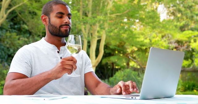 Man Enjoying Wine While Working on Laptop Outdoors - Download Free Stock Images Pikwizard.com