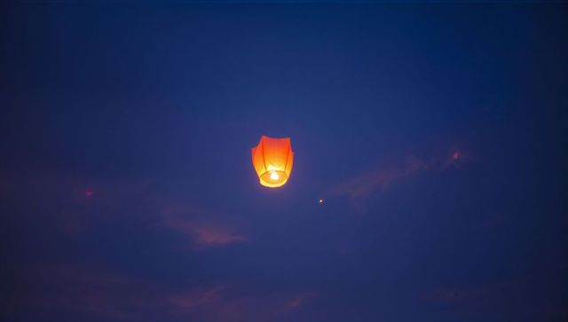 Sky lantern floating in twilight