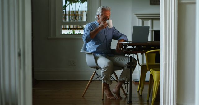 Senior Man Relaxing with Coffee While Using Laptop at Home - Download Free Stock Images Pikwizard.com