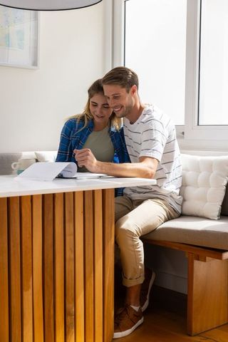 Couple Reviewing Documents in Cozy Home Setting