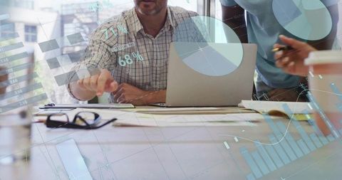 Business team collaborating and analyzing data on laptop with digital charts and graphs