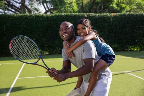 Father and Daughter Bonding on Tennis Court