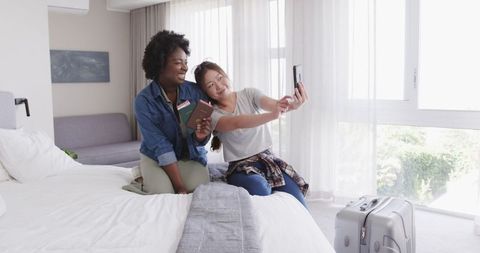Happy Multiracial Lesbian Couple Taking Selfie Before Vacation