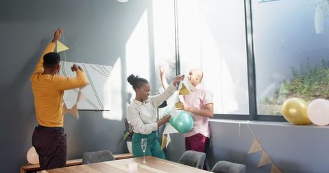 Friends celebrating indoor party with colorful decorations