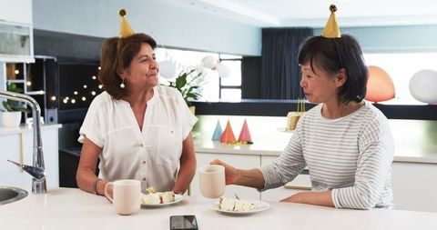 Senior Friends Enjoying Birthday Party with Cake and Coffee