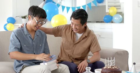 Father and Son Joyfully Celebrating Birthday at Home