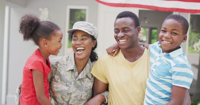 Image of happy african american family welcoming soldier mother returning home. family, togetherness, army and american patriotism concept.