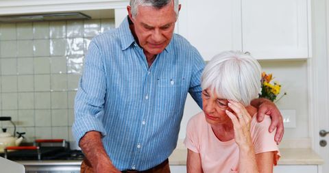 Supportive Senior Couple in Kitchen Handling Stressful Moment