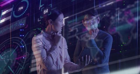 Innovative team analyzing data visualization in server environment