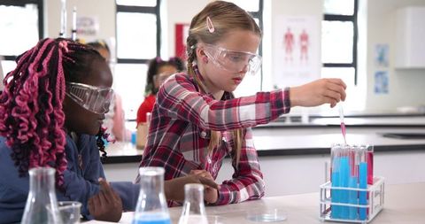 Schoolchildren Conducting Science Experiment in Laboratory