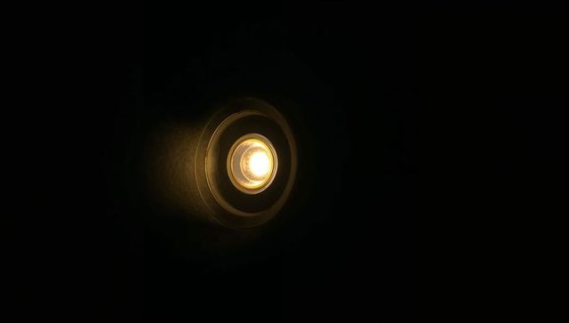 Emitting warm glow recessed spotlight revealing reflector rings and led bulb
