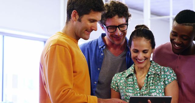 Diverse Team Collaborating on Tablet in Casual Office Environment - Download Free Stock Images Pikwizard.com