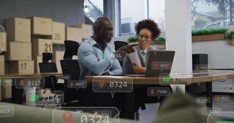 Colleagues Collaborating Over Laptop in Modern Office with Augmented Reality Data Analytics