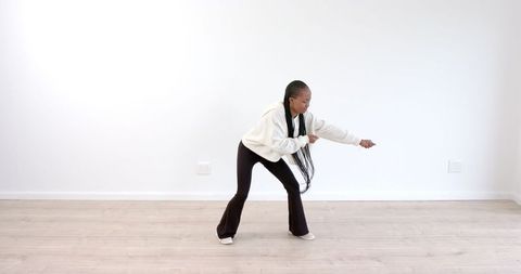 Woman Dancing Joyfully in Minimalist Space