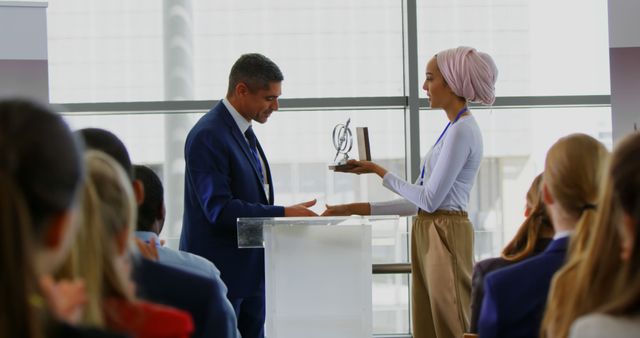 Businessman Presenting Award to Woman at Business Conference Event - Download Free Stock Images Pikwizard.com