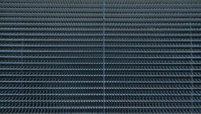 Symmetrical hvac heat exchanger fins closeup showing dense horizontal curled metal grille