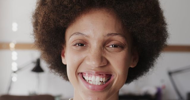 Smiling Young Woman with Curly Hair Highlighting Natural Beauty - Download Free Stock Images Pikwizard.com