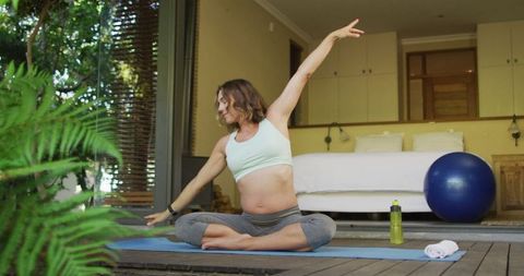 Pregnant Woman Practicing Yoga at Home in Serene Setting