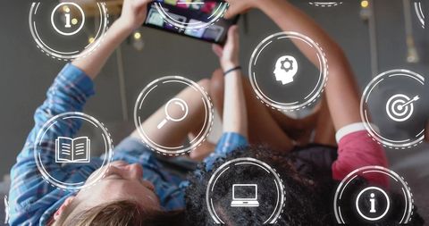 Women Engaging with Digital Data Icons on Smartphone