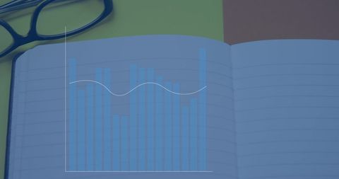 Graph Overlay on Notebook with Glasses on Desk