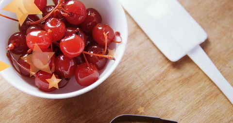 Fresh Red Maraschino Cherries in White Bowl on Wooden Counter